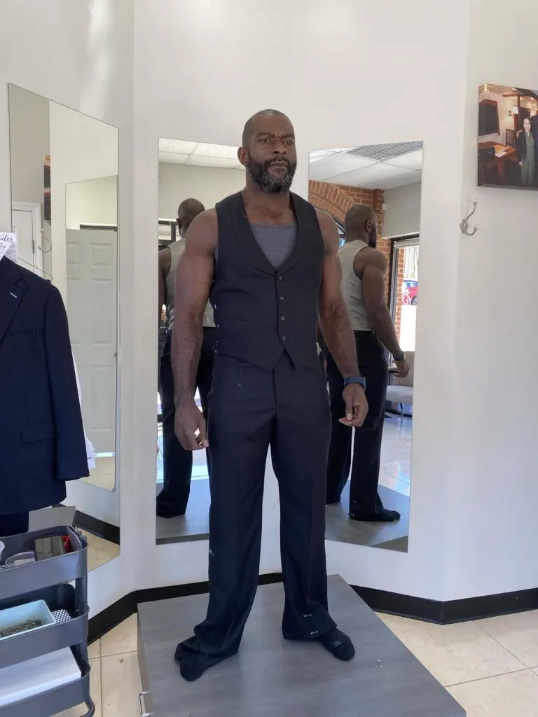 Athletically built client wearing a bespoke suit cut for broad shoulders and a narrow waist