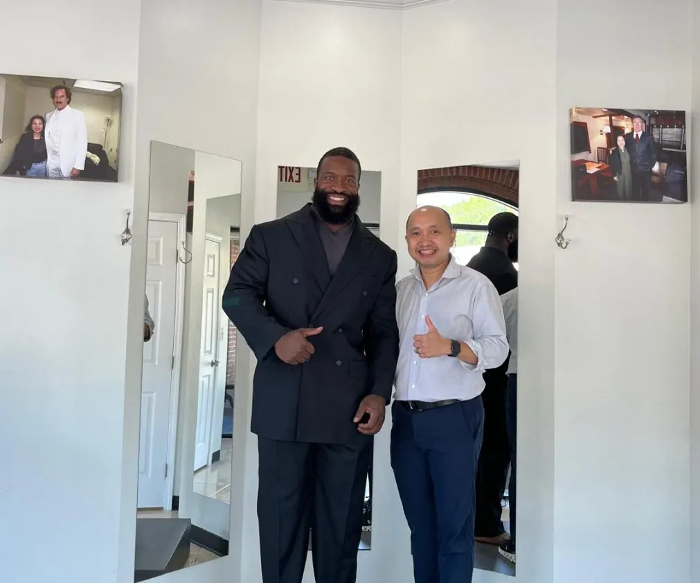 Athletically built client wearing a bespoke suit cut for broad shoulders and a narrow waist