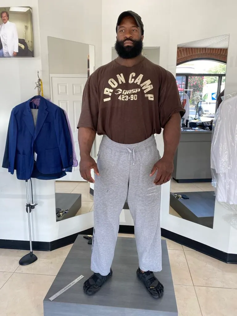 Athletically built client wearing a bespoke suit cut for broad shoulders and a narrow waist
