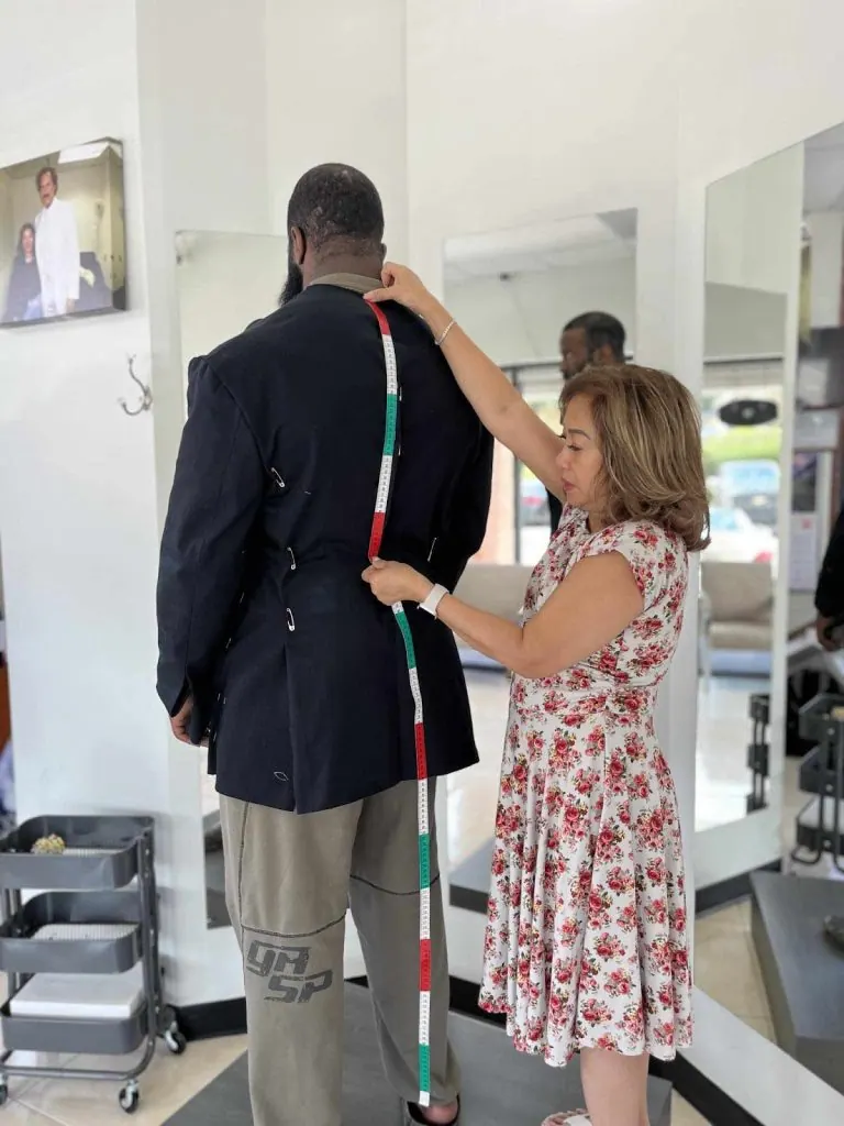 Athletically built client wearing a bespoke suit cut for broad shoulders and a narrow waist